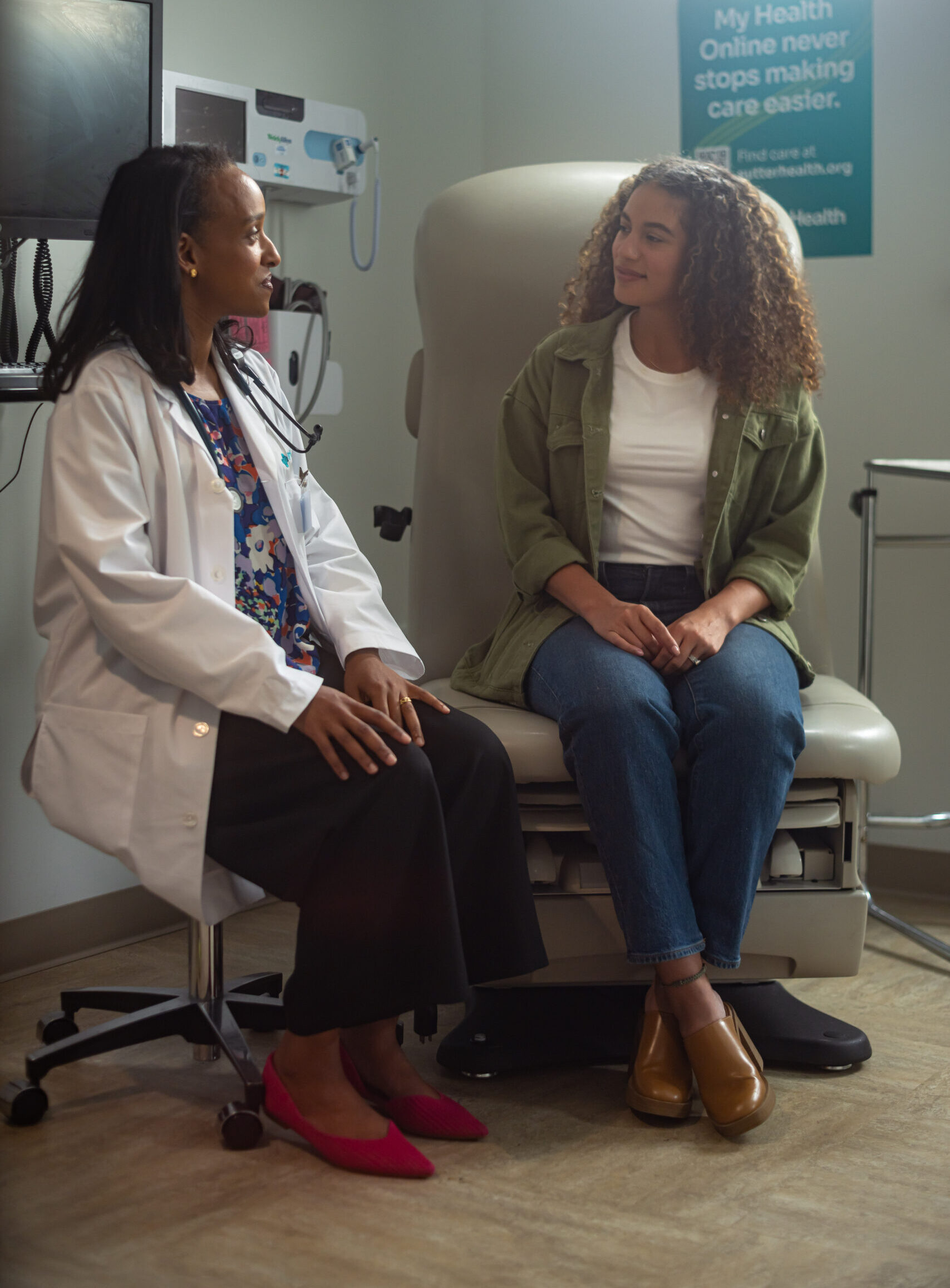 Doctor sitting with patient during consultation