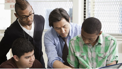 Teacher helping students