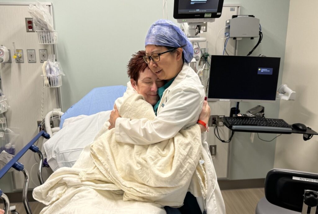 Patient hugging doctor