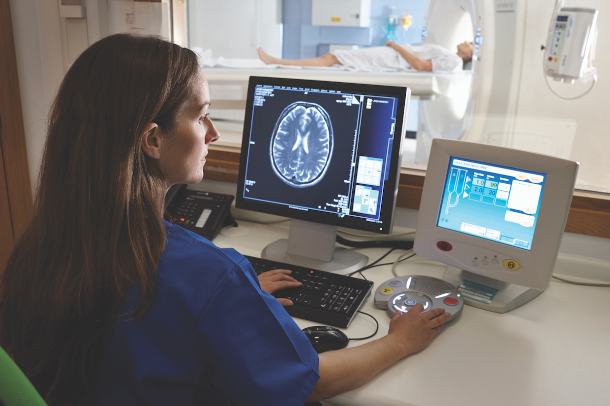 Physician looking at x-rays on computers