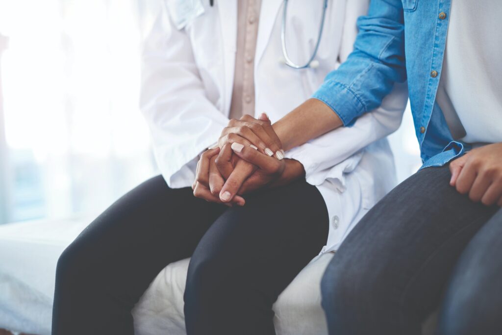 Doctor holding patients hand